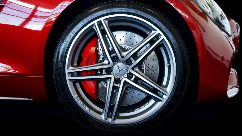 Side view of tyre rim of a red car