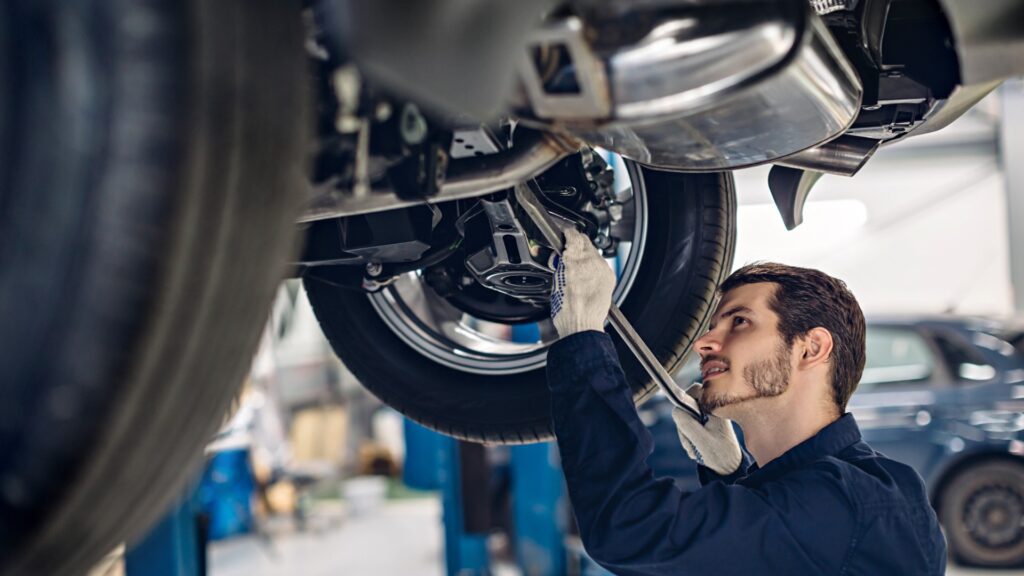 A mechanic checking the car for Warrant of Fitness